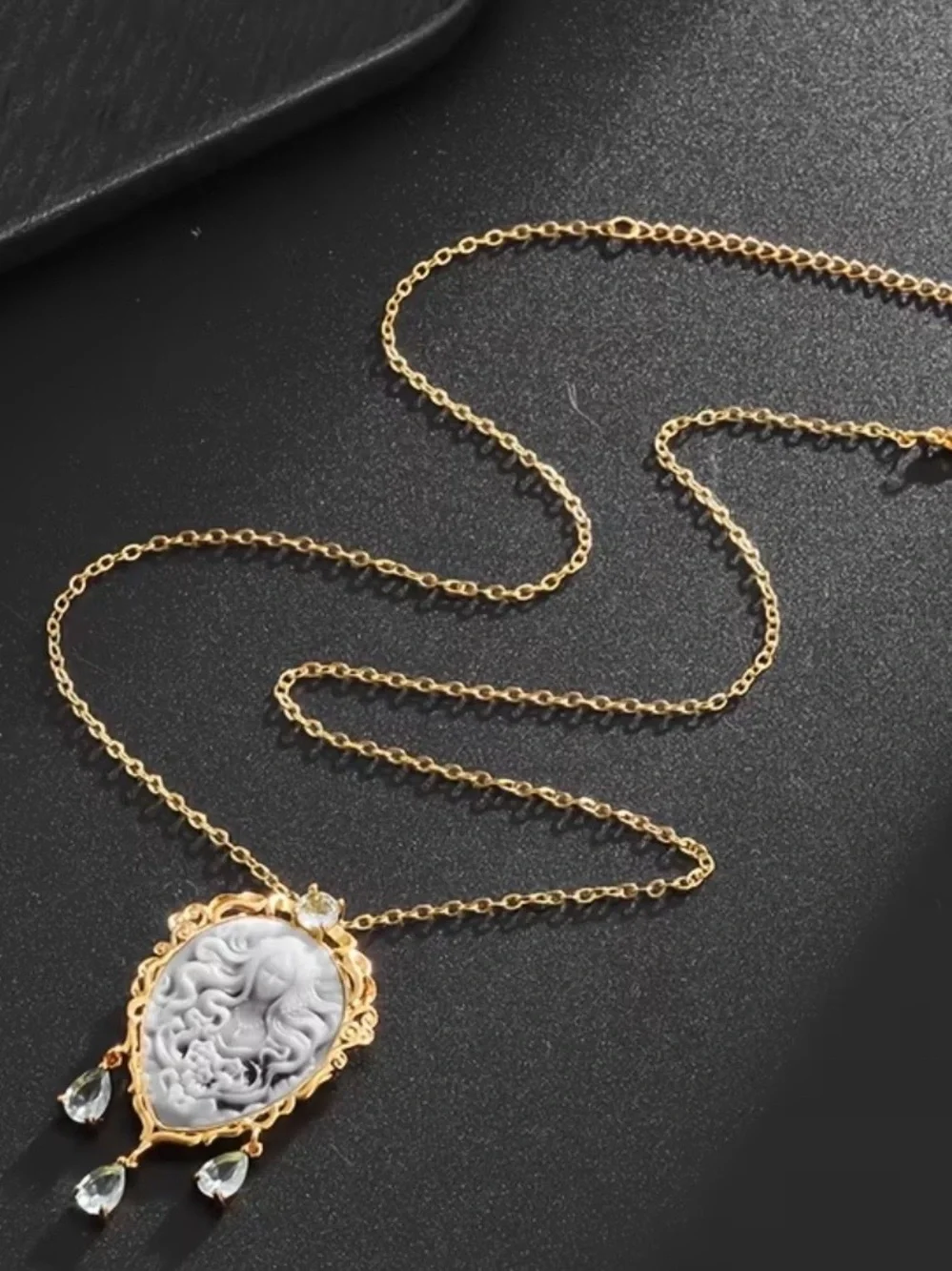 Gold Cameo Pendant Necklace with Gray Cameo and Light Blue Gem Drops